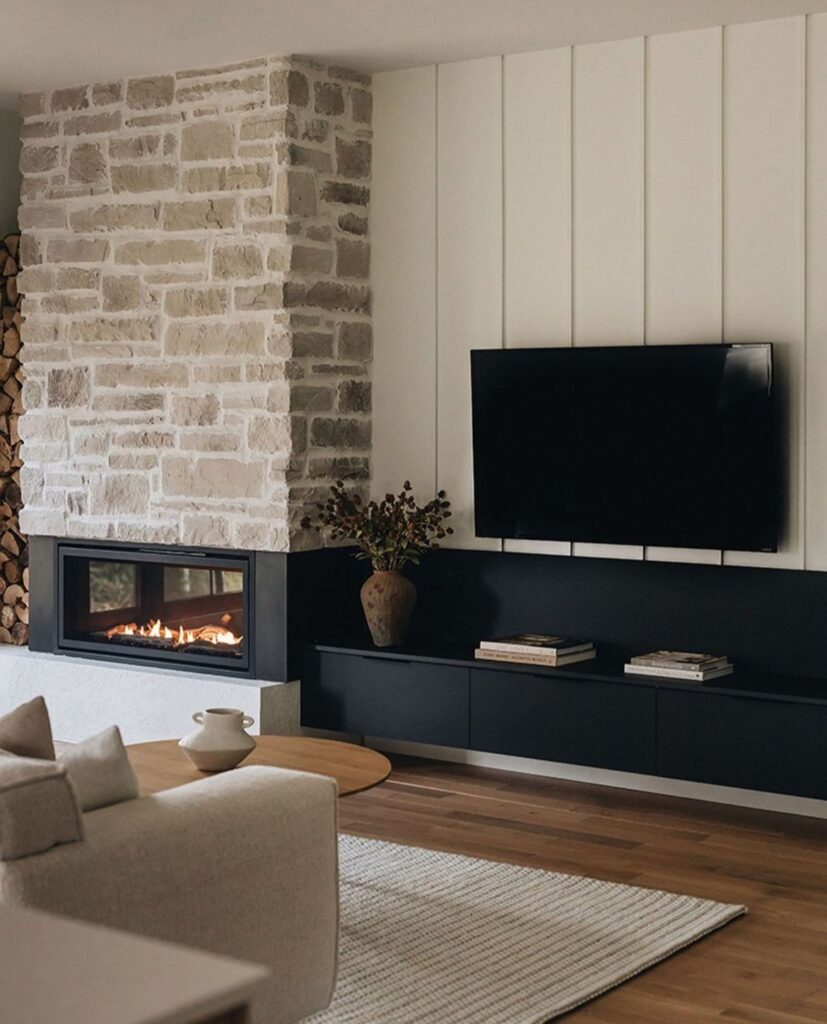 Modern living room with stone fireplace and mounted flat TV