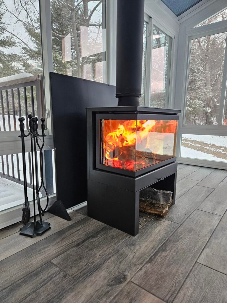 Modern wood stove burning bright in winter glass sunroom