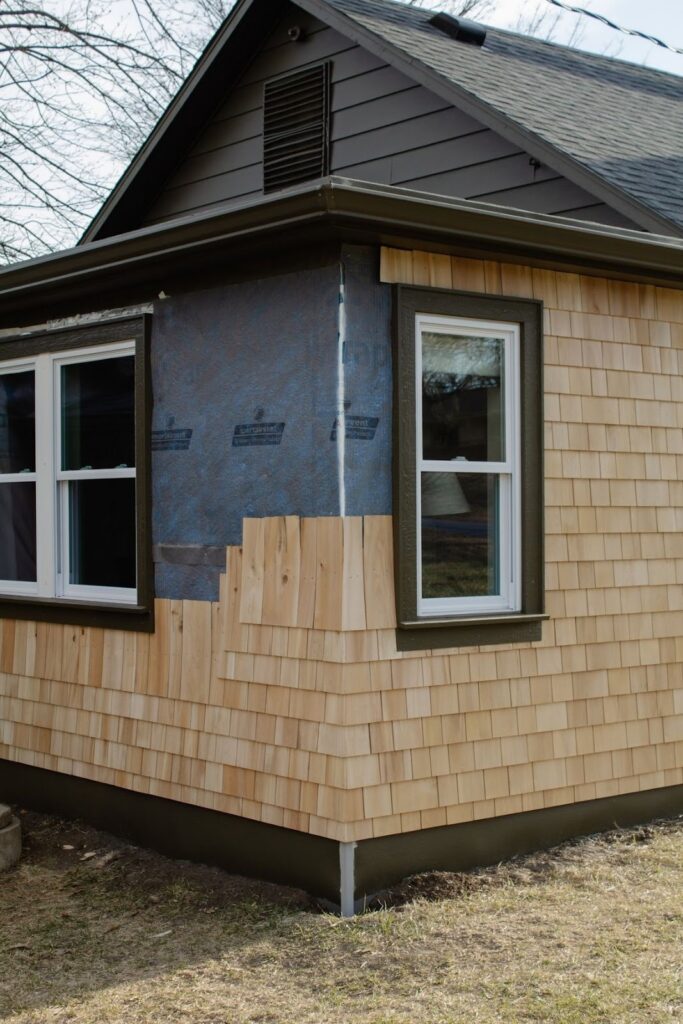 Cedar shake siding installation in progress on residential home