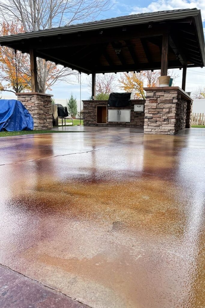 Stamped and stained concrete patio with outdoor kitchen pavilion
